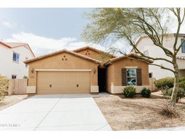 Charming single-story home with a two-car garage, stucco exterior, and well-maintained front yard at 25640 N 108Th Dr, Peoria, AZ 85383
