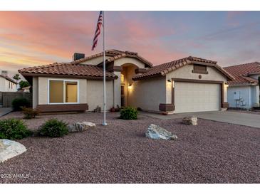 Charming single-story home boasts a desert landscape, neutral stucco, and a tile roof in a well-maintained neighborhood at 3443 E Wickieup Ln, Phoenix, AZ 85050