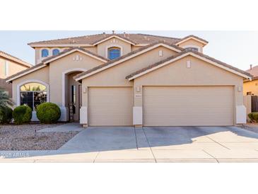 Spacious, two-story home featuring a three-car garage and manicured landscaping at 43615 W Roth Rd, Maricopa, AZ 85138