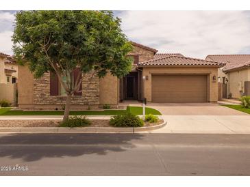 Charming single-story home featuring a lush front yard with a well-manicured lawn and desert landscaping at 5250 S Wesley Cir, Mesa, AZ 85212