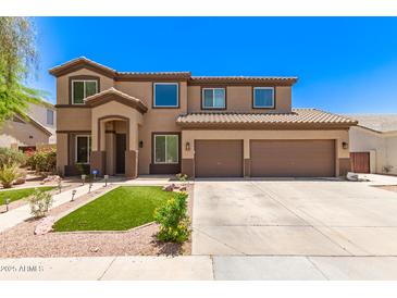 Inviting two-story home featuring a well-maintained lawn and a spacious two-car garage at 7385 W Honeysuckle Dr, Peoria, AZ 85383