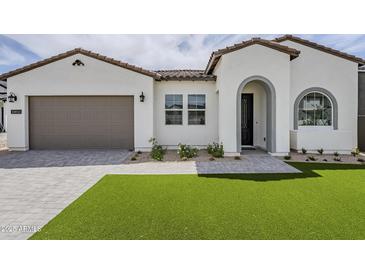 Beautiful white single-story home with well-maintained landscaping and a brown two-car garage at 11045 N Hershey St, Surprise, AZ 85388