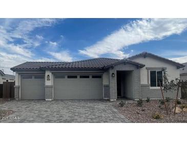 Charming single-story home with a three-car garage and beautiful brick accents at 12381 W Marguerite Ave, Avondale, AZ 85323