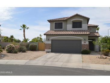 Charming two-story home featuring desert landscaping, a two car garage and a neutral color palette at 13486 W Evans Dr, Surprise, AZ 85379