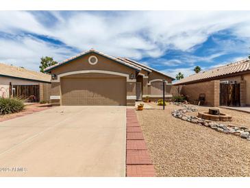 Cozy single-story home featuring a two-car garage and drought-resistant landscaping at 15980 W Smokey Dr, Surprise, AZ 85374
