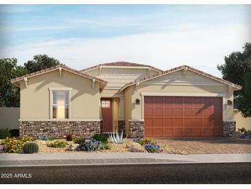 Charming single-story home with a well-manicured front yard and a two-car garage with brick veneer accents at 168 N 175Th Ave, Goodyear, AZ 85338