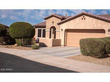 Beautiful single-Gathering home featuring a well-maintained exterior, neutral stucco, and a two-car garage at 17111 S 180Th Ln, Goodyear, AZ 85338
