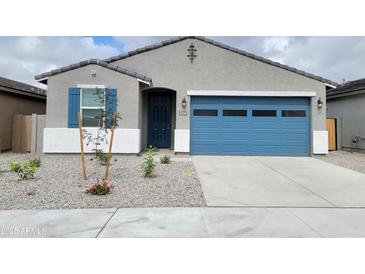 Charming single-story home with blue door, gray stone and a blue garage door at 19422 N Fiano Dr, Maricopa, AZ 85138