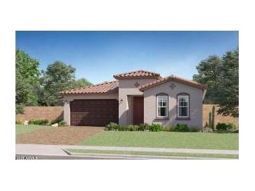 Charming single-story home featuring a red tile roof, manicured lawn, and attached two-car garage at 23081 E Saddle Way, Queen Creek, AZ 85142