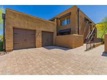 Inviting home featuring a multi-car garage and a charming, rustic exterior at 36600 N Cave Creek Rd # C7, Cave Creek, AZ 85331