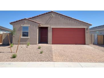 Charming single-story home with a red garage door and a low maintenance desert landscape at 4256 W Lisa Ln, San Tan Valley, AZ 85144