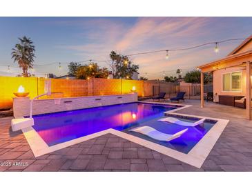 Inviting pool with water features and lounge chairs is perfect for relaxation and entertainment at 4446 W Kimberly Way, Glendale, AZ 85308