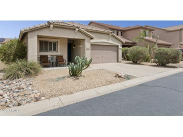 Inviting single-story home with desert landscaping, covered porch, and two-car garage at 4718 E Woburn Ln, Cave Creek, AZ 85331
