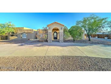 Stunning single-story home with a grand entrance, mature trees, and a circular driveway at 6519 E Cactus Rd, Scottsdale, AZ 85254