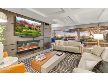 Modern living room featuring a fireplace, TV, comfortable seating, and beautiful views at 7167 E Rancho Vista Dr # 5001, Scottsdale, AZ 85251