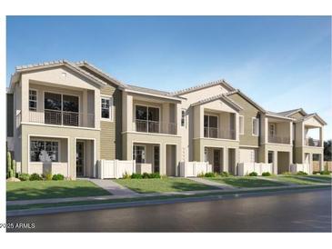 New townhomes with landscaped front yards and white picket fences at 8149 E Petunia Ave # 1007, Mesa, AZ 85212