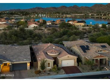 Beautiful single-Gathering home with lake view and lush desert landscaping at 10507 S 181St Ave, Goodyear, AZ 85338