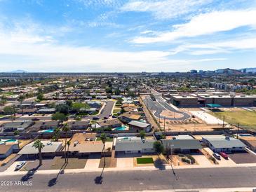 Expansive aerial view of a neighborhood with mature trees and clear blue skies at 1209 E Marigold Ln, Tempe, AZ 85288