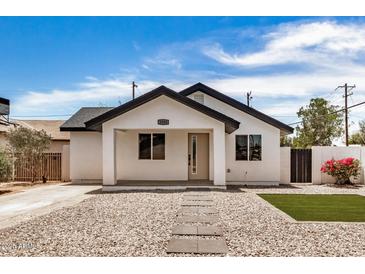 Charming single-story home featuring modern design, xeriscape, and vibrant bougainvillea at 1501 E Sheridan St, Phoenix, AZ 85006