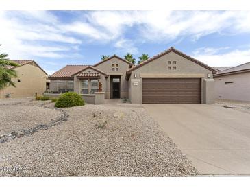 Charming single-story home featuring a well-manicured desert landscape and two-car garage, in a sunny neighborhood at 16514 W Sandia Park Dr, Surprise, AZ 85374