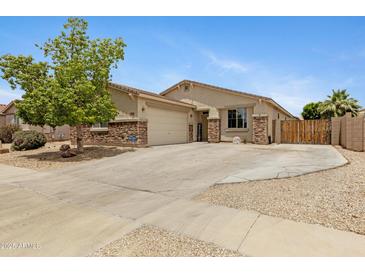 Charming single-story home featuring stone accents, a well-manicured lawn, and a welcoming facade at 17292 W Pinnacle Vista Dr, Surprise, AZ 85387