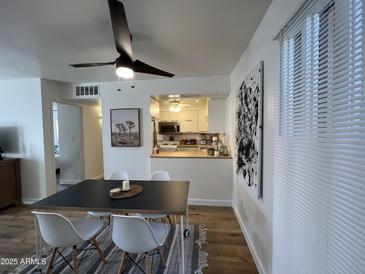Bright dining area featuring a modern table, stylish chairs, and an open view to the kitchen at 1823 E Kirkland Ln # C, Tempe, AZ 85281