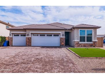 Charming single-story home showcasing a three-car garage and a meticulously paved driveway for added curb appeal at 3623 S 78Th Dr, Phoenix, AZ 85043