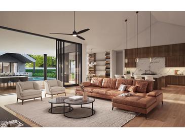 Bright living room featuring an open layout, modern furniture, and seamless indoor-outdoor flow to the pool area at 13402 N 79Th St, Scottsdale, AZ 85260