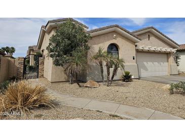 Charming single-story home with low-maintenance desert landscaping and a two-car garage at 14380 W Monte Vista Rd, Goodyear, AZ 85395