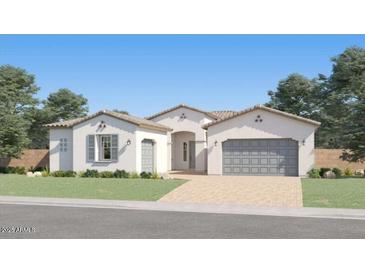 Charming single-story home with a neutral color scheme, a well-manicured lawn, and an attached two-car garage at 17403 W Swayback Pass, Surprise, AZ 85387