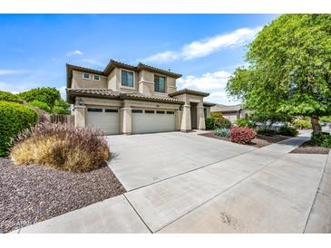 Charming two-story home with a three car garage, landscaped yard, and beautiful desert vegetation at 19242 W Pasadena Ave, Litchfield Park, AZ 85340