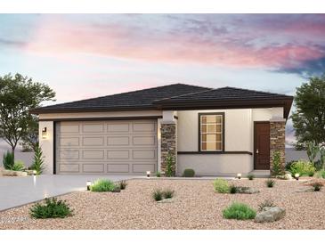 Charming single-story home featuring desert landscaping, stone accents, and a two-car garage at 22824 N 182Nd Ln, Surprise, AZ 85387