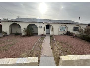 Charming home featuring arched entryways and desert landscaping, creating a unique curb appeal at 3062 N 42Nd Ave, Phoenix, AZ 85019