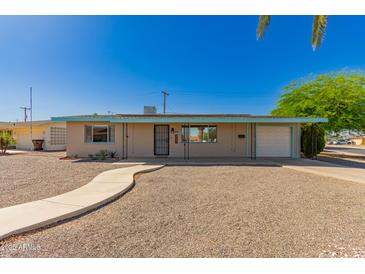Charming single-story home with a well-maintained yard and inviting walkway at 5627 E Covina Rd, Mesa, AZ 85205