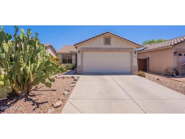 Charming single-story home featuring a two-car garage and desert landscaping at 645 W Kingman Loop, Casa Grande, AZ 85122