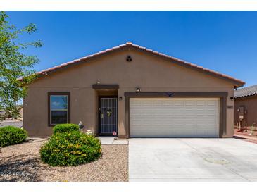 Charming single-story home featuring a two-car garage and low maintenance desert landscaping in the front yard at 8012 S Magic Dr, Casa Grande, AZ 85193