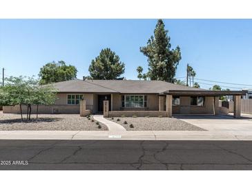 Charming single-story home featuring a brick facade, covered parking, and low-maintenance landscaping at 2156 E Cairo Dr, Tempe, AZ 85282
