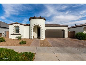 Charming single-story home featuring a unique turret entry, tile roof, and attached two-car garage at 23503 S 228Th Pl, Queen Creek, AZ 85142