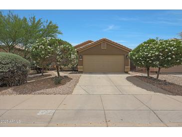 Charming single-story home featuring a well-manicured lawn and a two-car garage at 2627 E Gary Way, Phoenix, AZ 85042