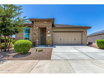 Charming single-story home featuring a stone-accented entrance and a two-car garage at 41825 W Mesquite Rd, Maricopa, AZ 85138