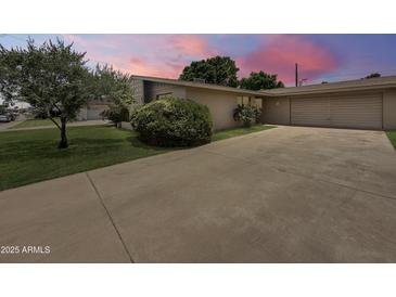 Single story home with a well manicured yard and large driveway at 4533 W Cavalier Dr, Glendale, AZ 85301