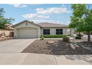 Charming single-story home with a well-maintained front yard and a two-car garage at 6439 W Kristal Way, Glendale, AZ 85308