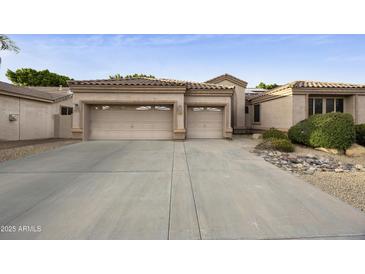 Charming single-story home with a two-car garage and desert landscaping at 7262 W Firebird Dr, Glendale, AZ 85308