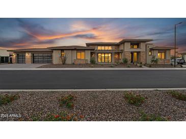 Striking modern home featuring desert landscaping and a large garage at 24138 S 220Th St, Queen Creek, AZ 85142