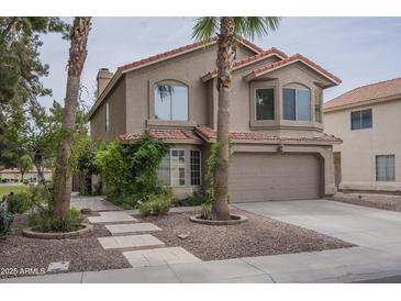 Charming two-story home featuring a two-car garage, desert landscaping, and a red tile roof at 533 N Cobblestone St, Gilbert, AZ 85234