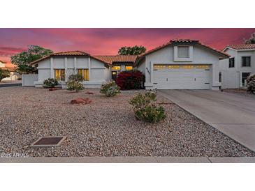 Charming single-story home features a two-car garage, gravel landscaping, and a new roof at 6145 E Snowdon St, Mesa, AZ 85215