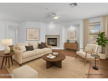 Bright living room with fireplace, neutral decor and a ceiling fan at 11500 E Cochise Dr # 2001, Scottsdale, AZ 85259