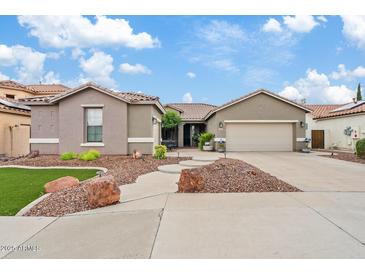 Charming single-story home with a well-manicured front yard and a two-car garage at 13629 W San Miguel Ave, Litchfield Park, AZ 85340