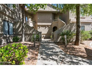 Inviting condo exterior featuring well-maintained landscaping and private entrances at 15252 N 100Th St # 1147, Scottsdale, AZ 85260