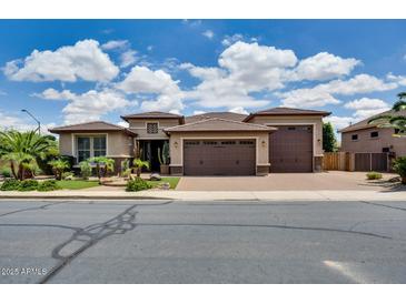 Charming single-story home featuring a three-car garage, desert landscaping, and a brick driveway at 16141 N 183Rd Dr, Surprise, AZ 85388